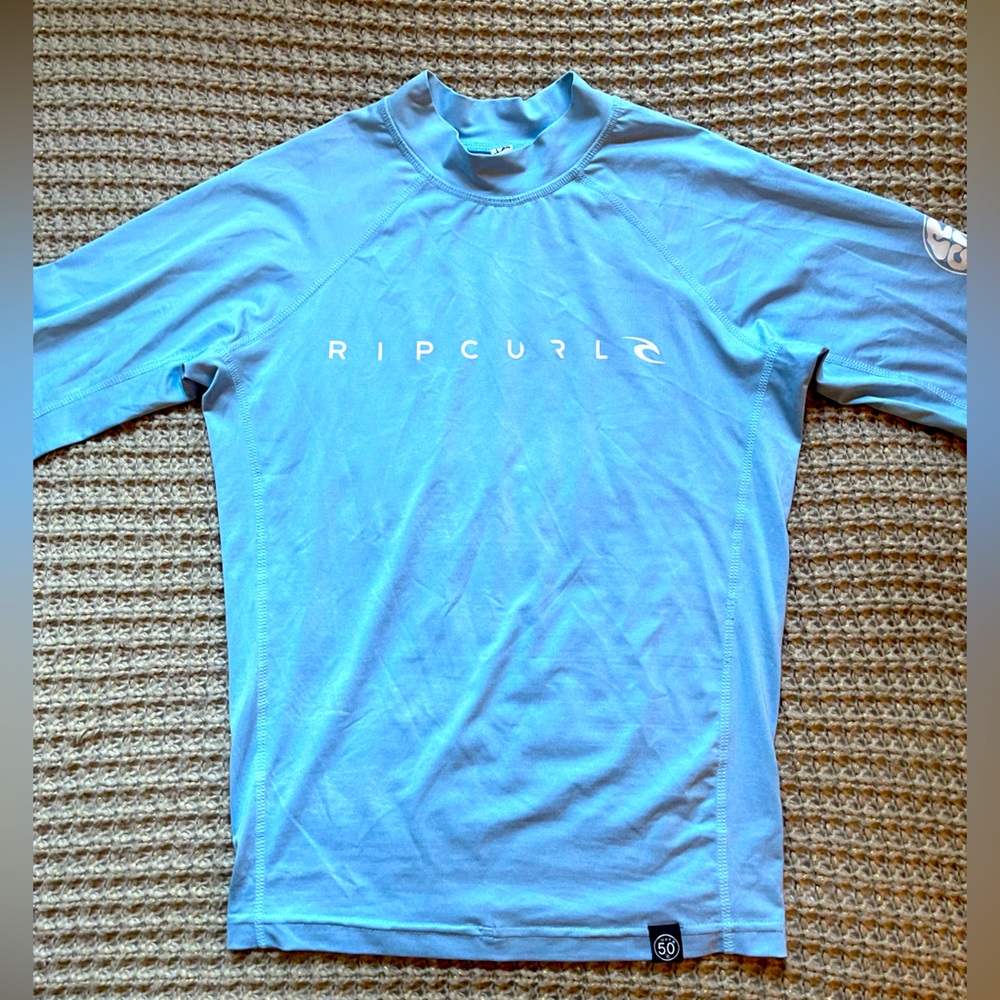 Rip Curl Short Sleeved Blue Rashguard. Size 16. Very good condition.